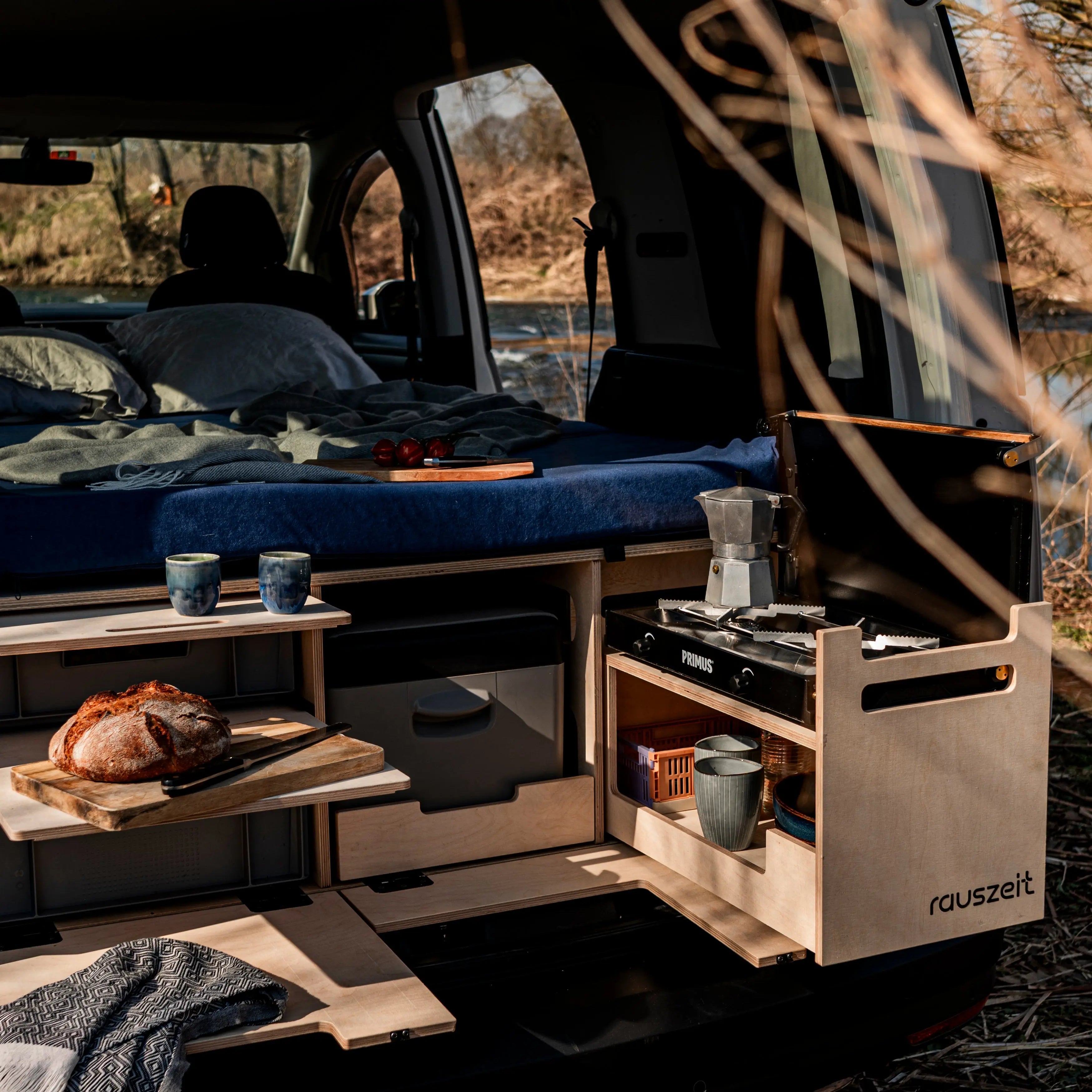 Kochmodul Seitenansicht mit Gaskocher, Schneidebrett und Stauraum in der Campingbox