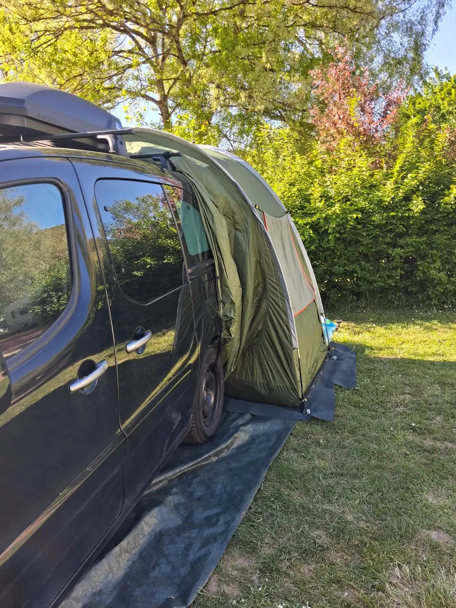 Hochdachkombi mit Campingbox und angebautem Vorzelt auf einem Campingplatz